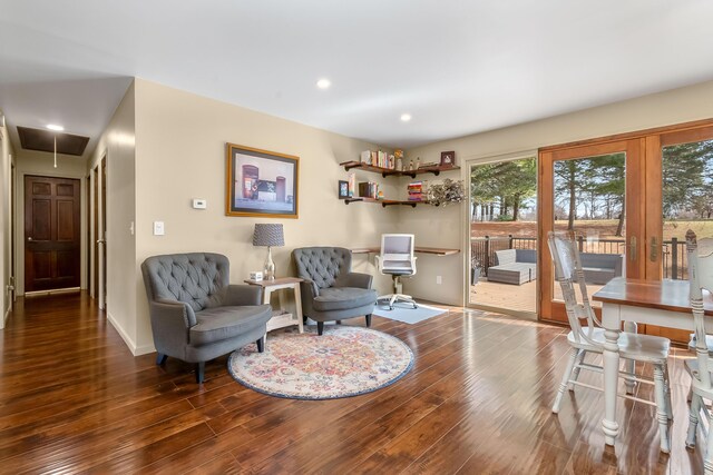 living area with recessed lighting, attic access, baseboards, and wood finished floors