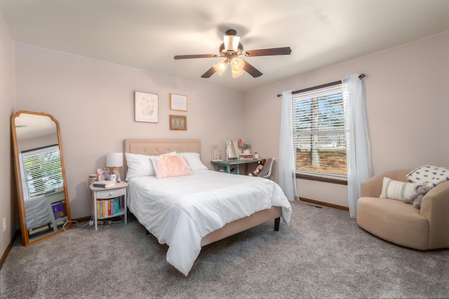 bedroom with baseboards, carpet floors, and ceiling fan