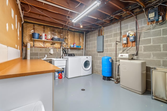 unfinished below grade area featuring washing machine and dryer and concrete block wall