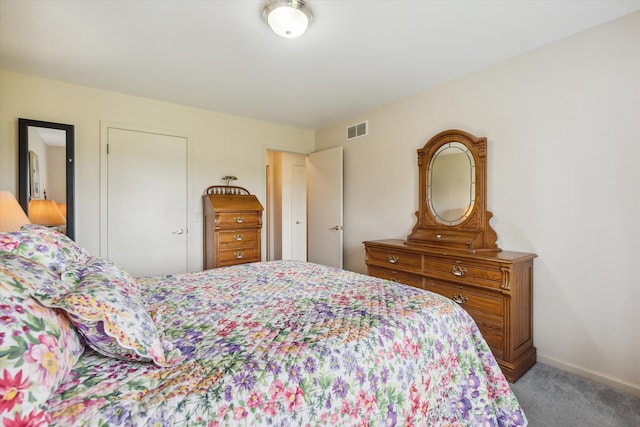 carpeted bedroom with visible vents and baseboards