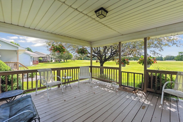 wooden deck featuring a lawn