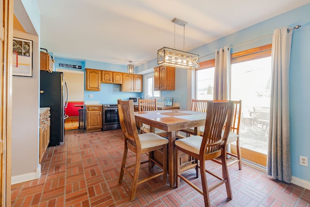 dining area with brick floor and baseboards