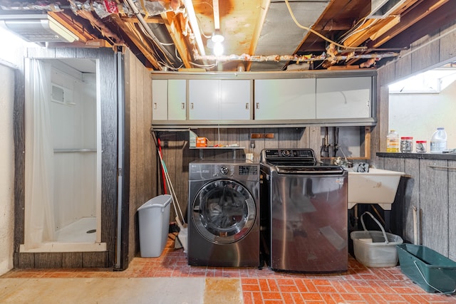 laundry room featuring a sink and separate washer and dryer