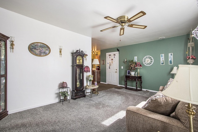 living room with carpet flooring, baseboards, and ceiling fan