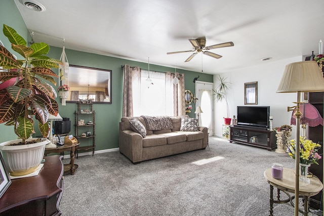 carpeted living area featuring a ceiling fan and visible vents