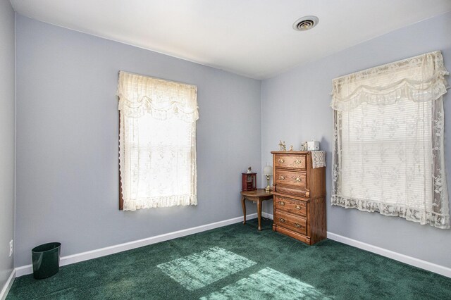 carpeted bedroom with visible vents and baseboards