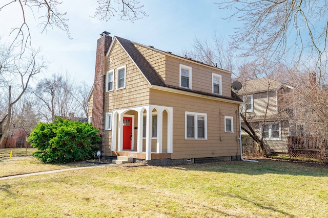 view of front facade with a front lawn, fence, roof with shingles, and a chimney