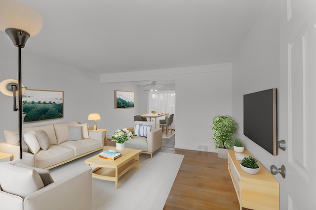 living area with visible vents, ceiling fan, and light wood finished floors