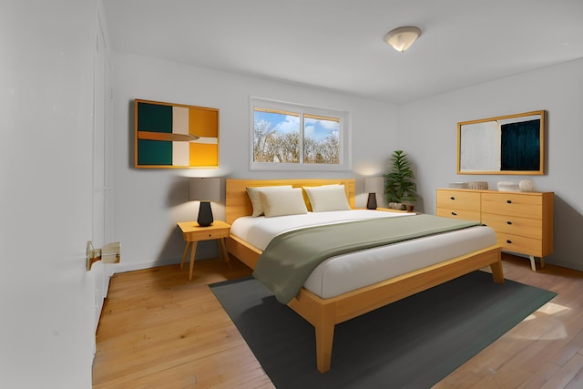 bedroom with light wood finished floors and baseboards