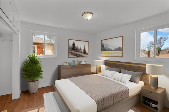 bedroom with baseboards and light wood finished floors