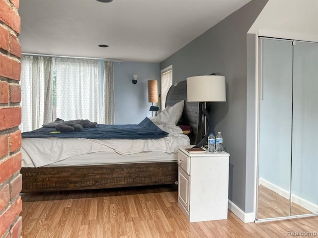 bedroom featuring light wood-style flooring and baseboards