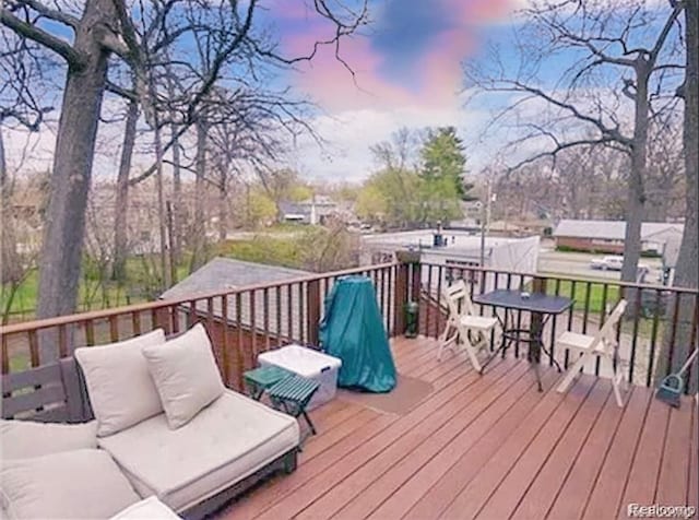 deck at dusk featuring an outdoor living space