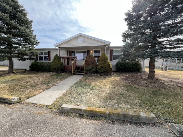 view of front of home with a porch and a front lawn