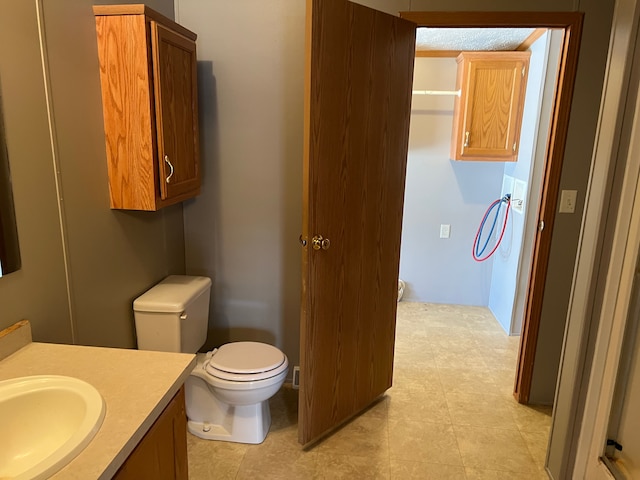 bathroom featuring toilet and vanity