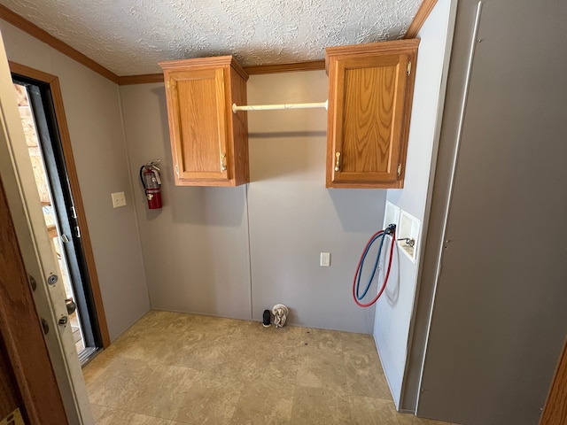 laundry room featuring washer hookup, cabinet space, and a textured ceiling