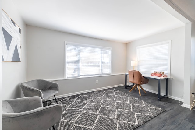 living area featuring dark wood finished floors and baseboards