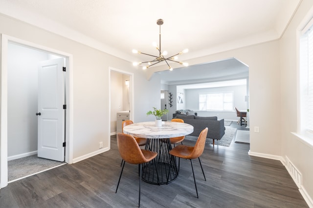 dining room with dark wood finished floors, visible vents, baseboards, and an inviting chandelier