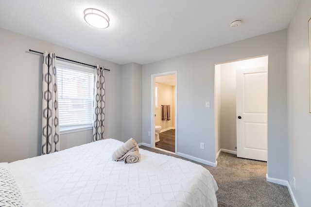 carpeted bedroom with baseboards and ensuite bathroom