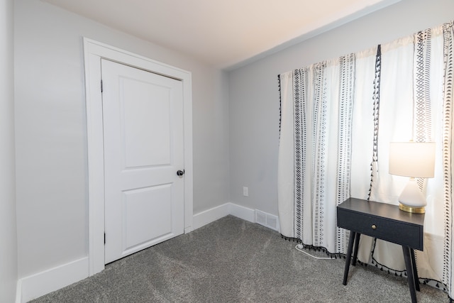 bedroom featuring baseboards, visible vents, and dark carpet