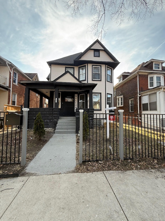 view of front of home with a porch and a fenced front yard