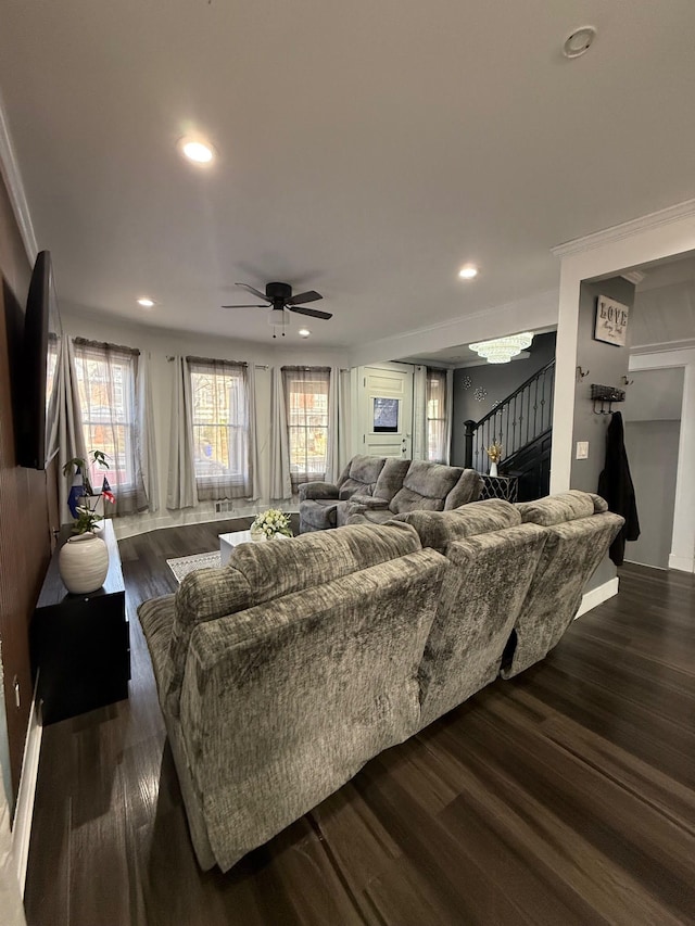 living room featuring a wealth of natural light, stairway, and dark wood-style flooring