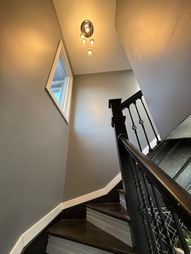 staircase featuring baseboards