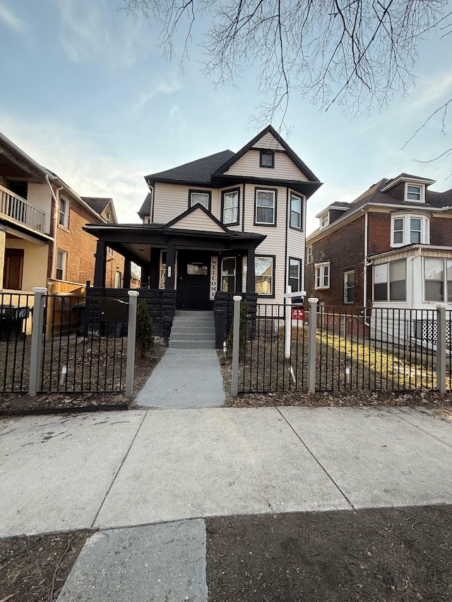 view of front facade featuring a porch and a fenced front yard