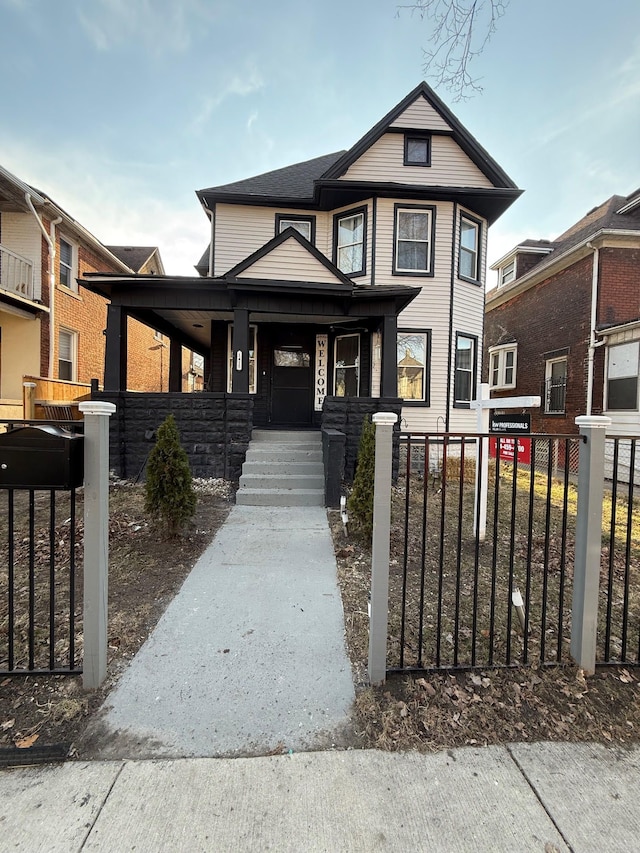 view of front facade featuring fence and covered porch