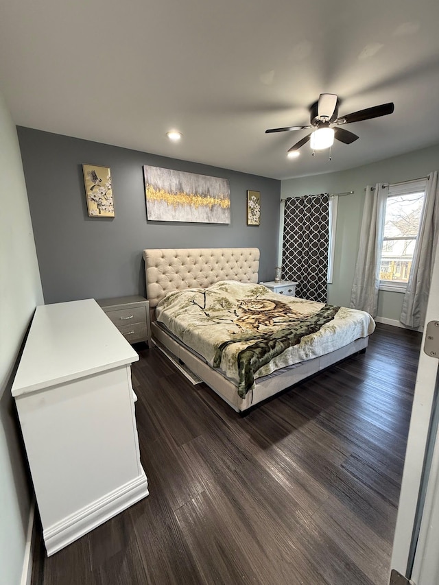 bedroom with baseboards, dark wood finished floors, and a ceiling fan