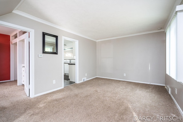 unfurnished room with carpet flooring, baseboards, visible vents, and ornamental molding