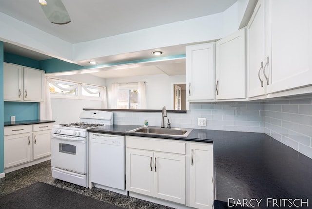 kitchen with white appliances, a sink, white cabinetry, dark countertops, and backsplash