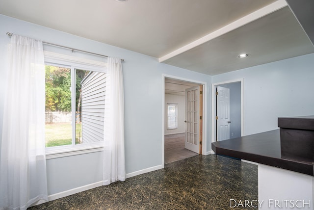 unfurnished dining area featuring granite finish floor, plenty of natural light, recessed lighting, and baseboards