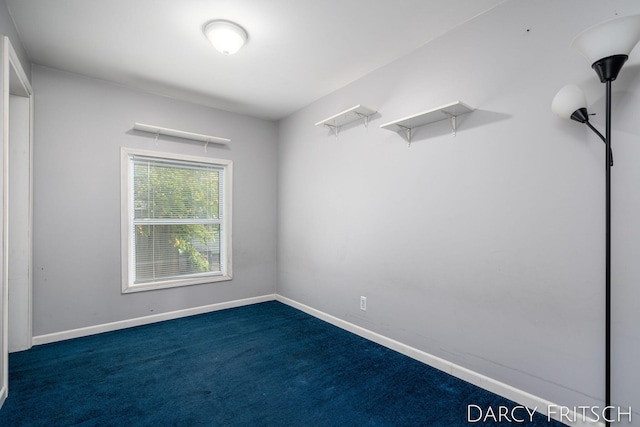 unfurnished room with baseboards and carpet