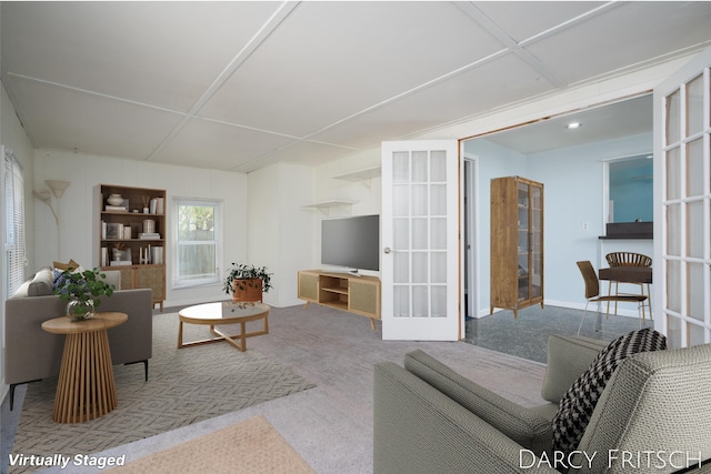 carpeted living room featuring french doors