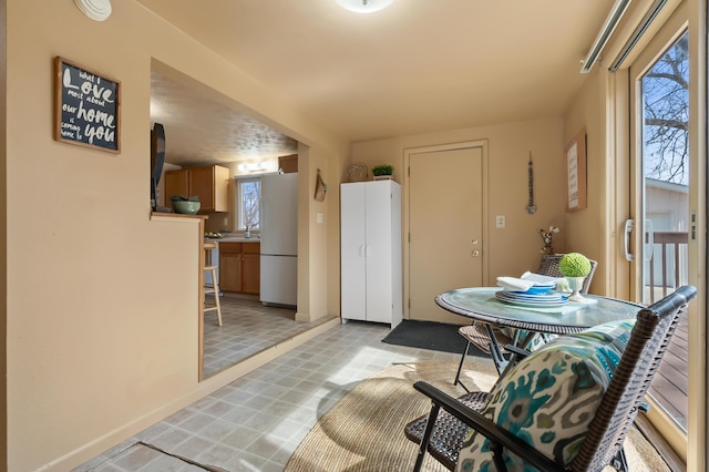 dining space featuring baseboards