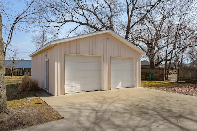 detached garage featuring fence