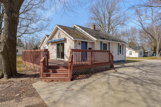 view of front of home featuring a deck and a chimney