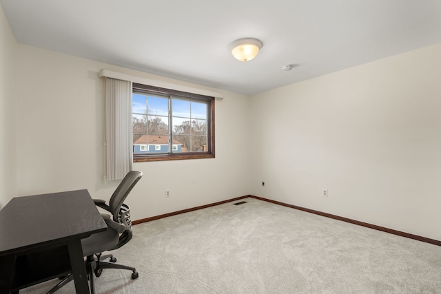 carpeted office space with visible vents and baseboards