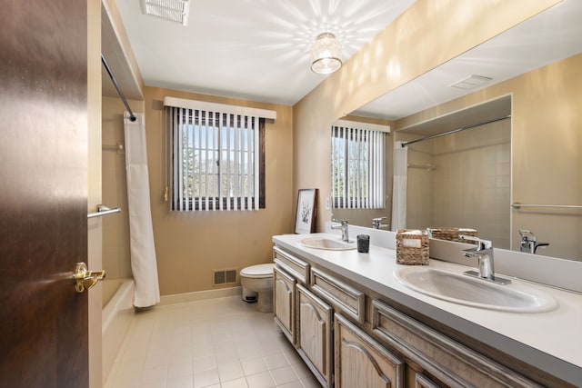 bathroom with visible vents, a healthy amount of sunlight, and a sink