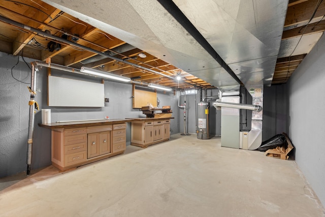 unfinished basement with gas water heater, heating unit, and a workshop area