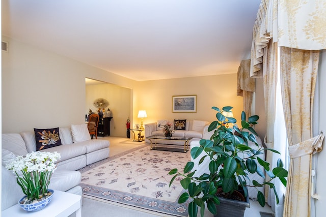 carpeted living area featuring visible vents