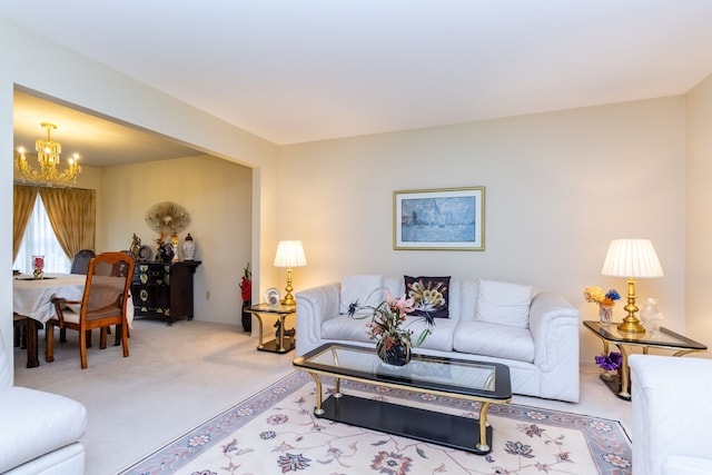 living area featuring a notable chandelier and carpet