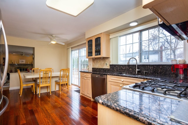 kitchen with dark wood-type flooring, a sink, tasteful backsplash, glass insert cabinets, and dishwasher