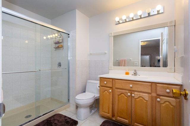 full bath featuring vanity, tile patterned flooring, a shower stall, tile walls, and toilet