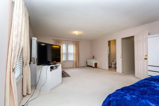 carpeted bedroom featuring a textured ceiling