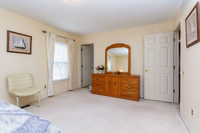 bedroom featuring light colored carpet and visible vents