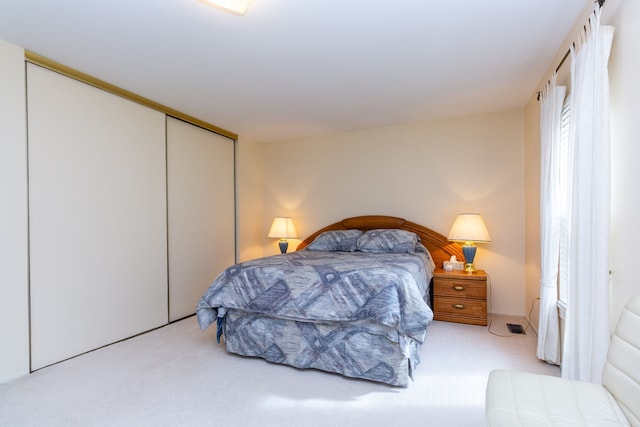 carpeted bedroom featuring a closet