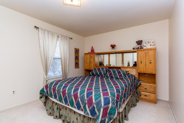 bedroom featuring baseboards and light colored carpet