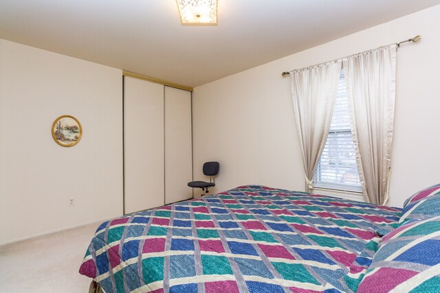 carpeted bedroom featuring a closet