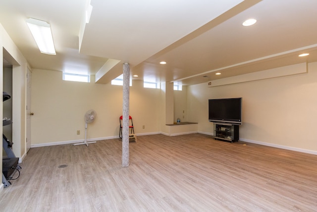 basement featuring recessed lighting, light wood-style floors, and baseboards